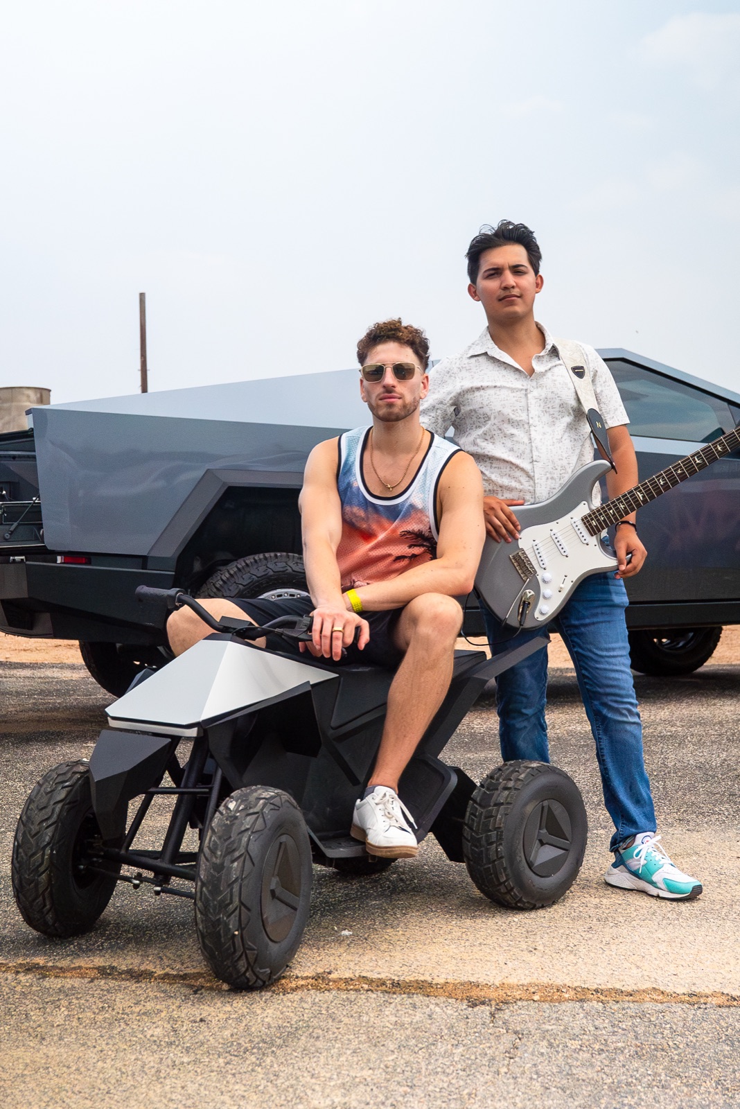 Jordan Miller and Kristian Cruz with a Tesla Cybertruck and Cyberquad at the Cybertruck Rodeo Texas Monthly covered