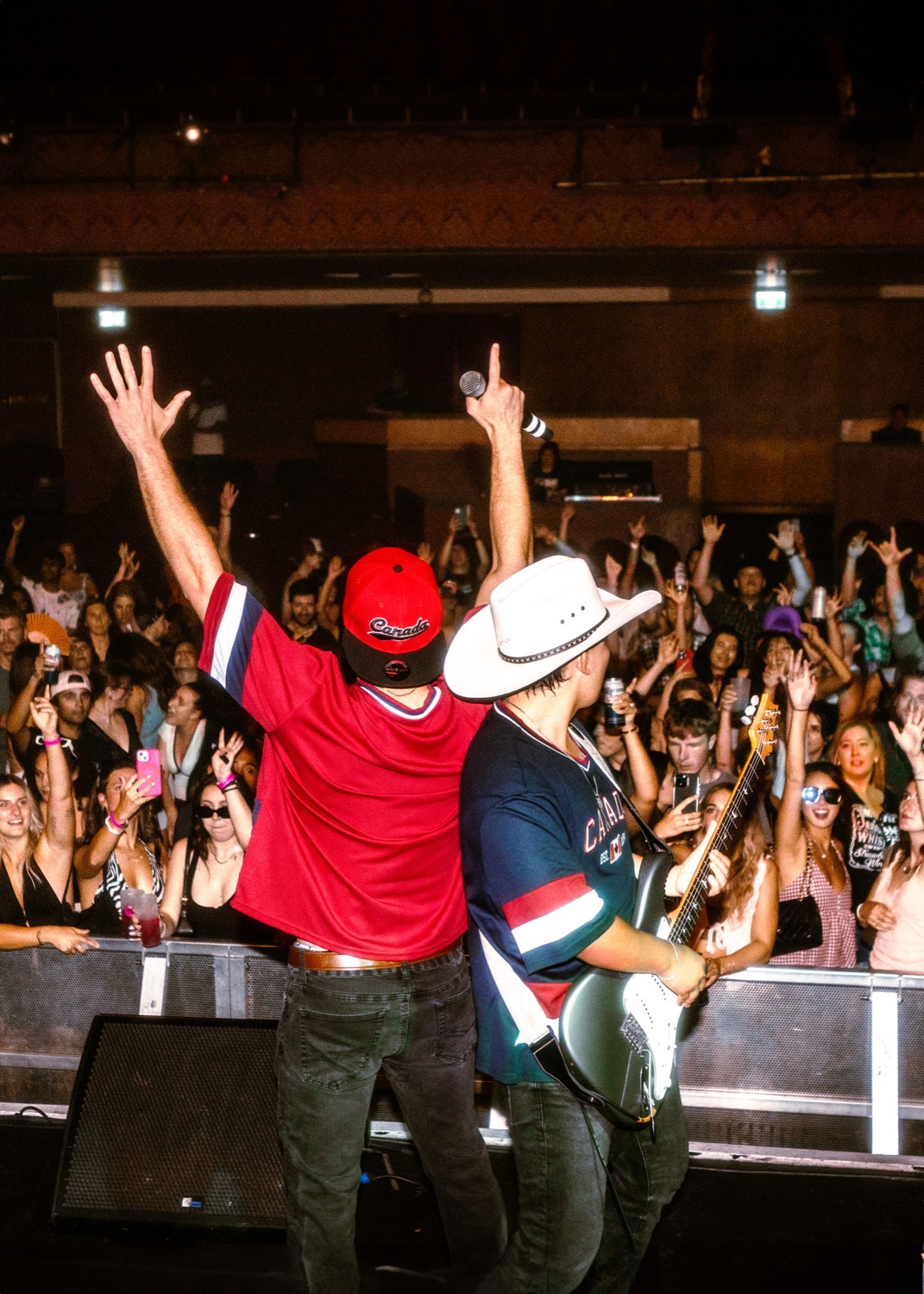 Mixmode playing to a packed Vogue Theatre crowd in Vancouver with hands in the air